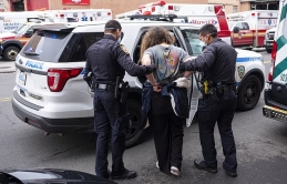 Shocking moment man in medical mask sucker punches NYPD cop who was arresting a suspect in the Bronx